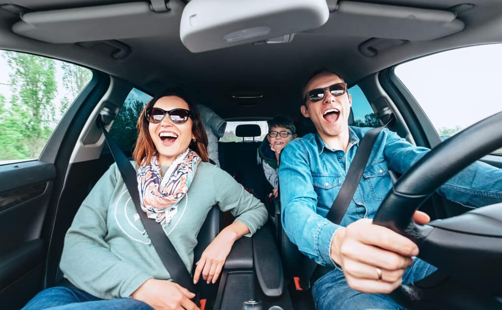 happy family singing together in car