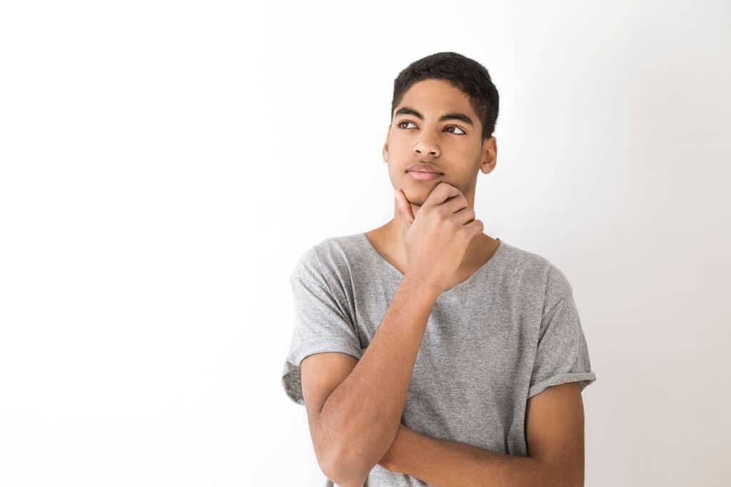 teen boy looking pensively off into space