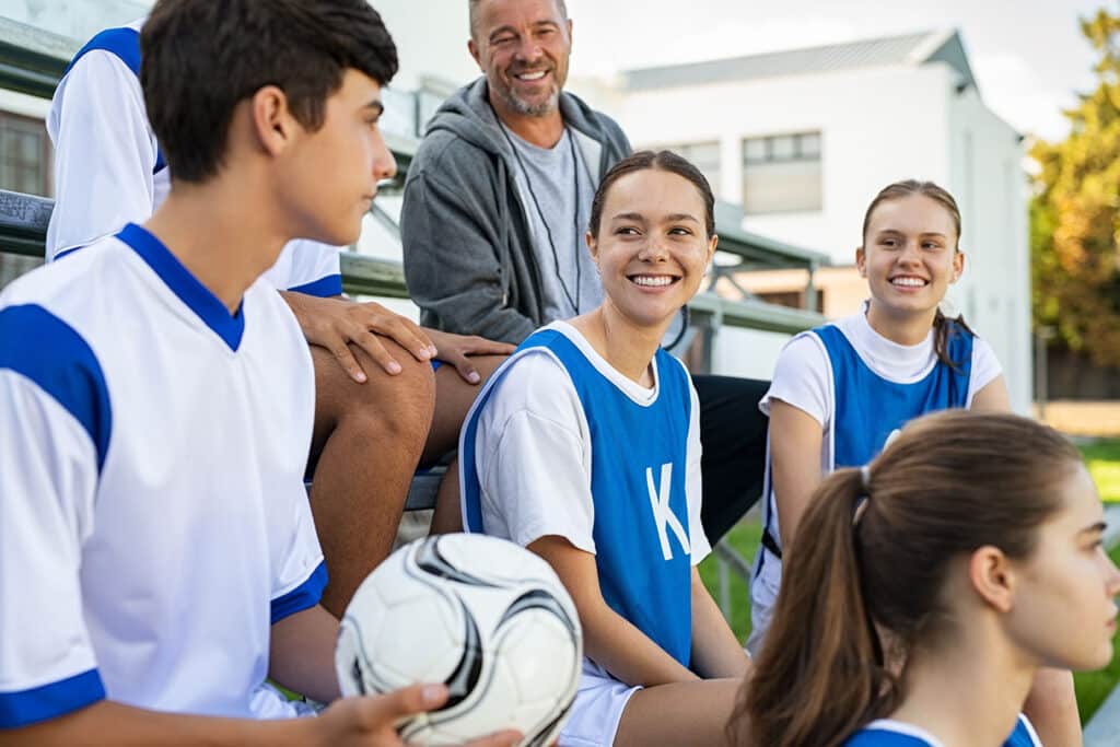 soccer team sitting on bleachers