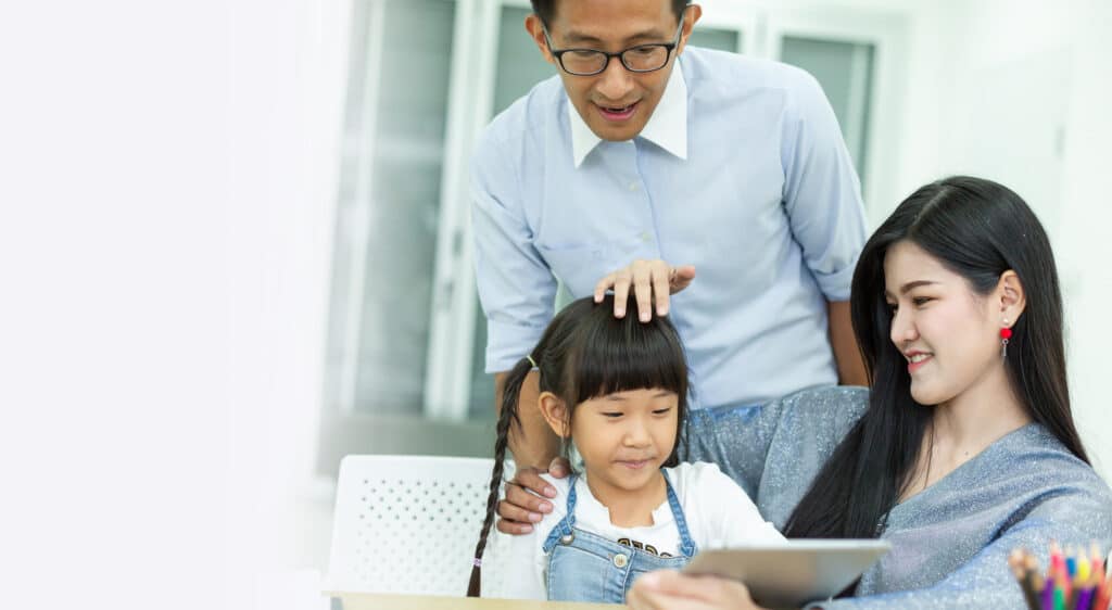 family looking at ipad together