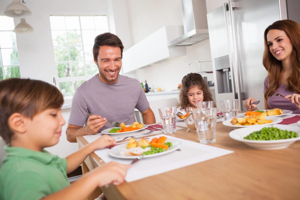 family smiling at the dinner table