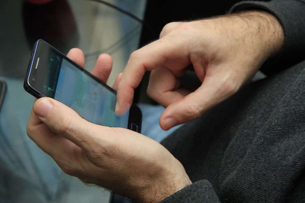 male hands holding cell phone