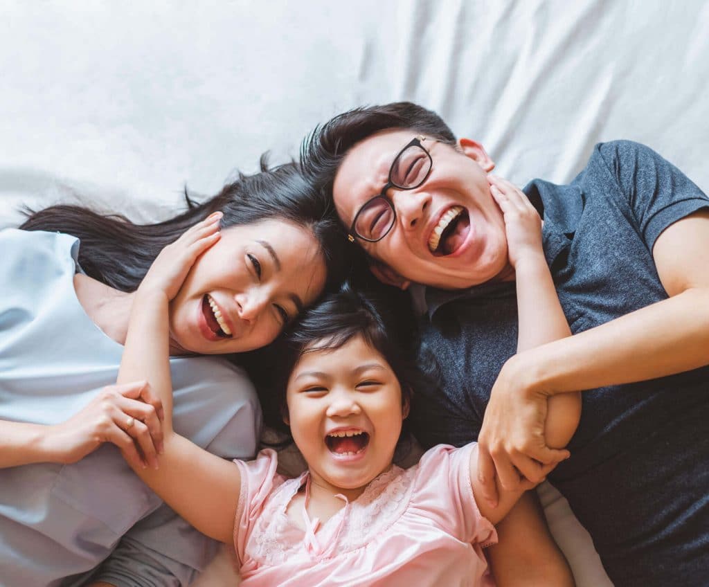 Parents and daughter laughing