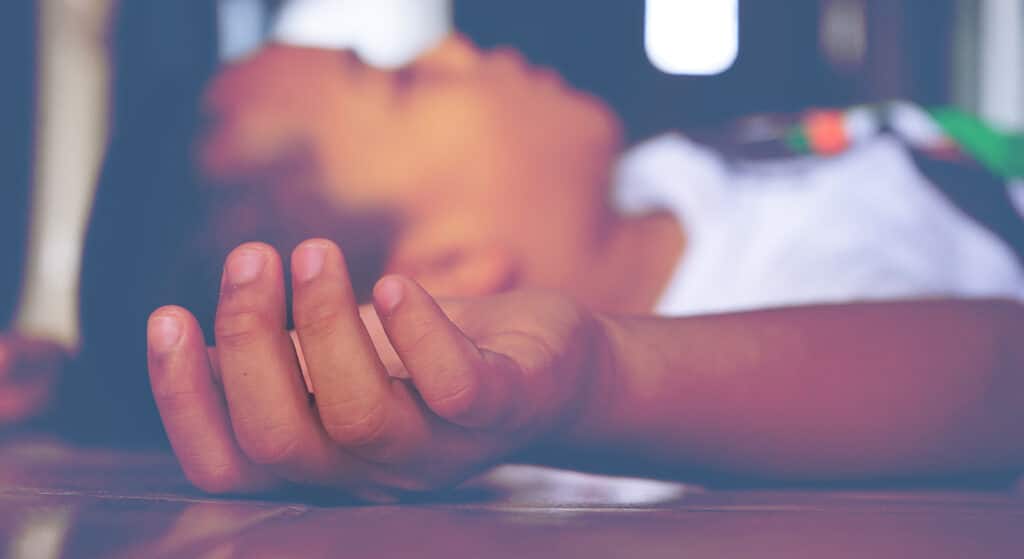 child laying on their back with eyes closed