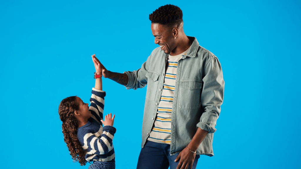 happy father and daughter high fiving